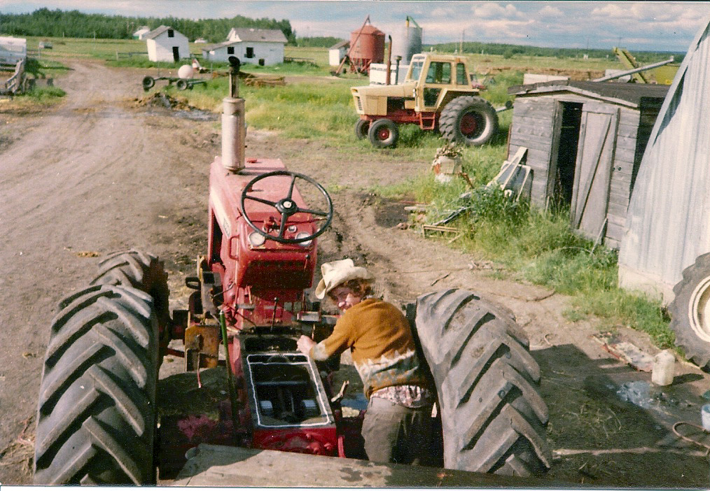 Hands repairing farm equipment